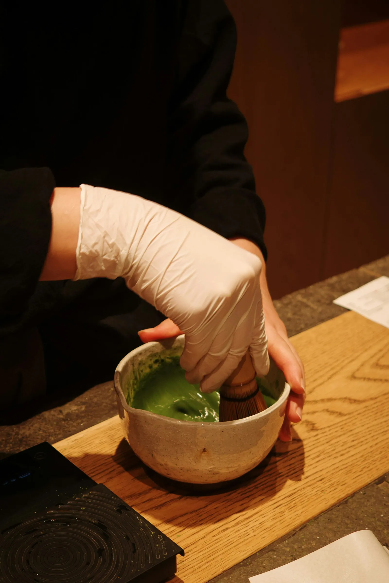 Matcha tea being prepared in a traditional bowl